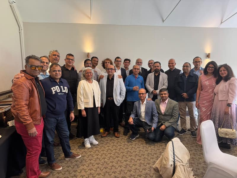Large group of alumni posing together indoors